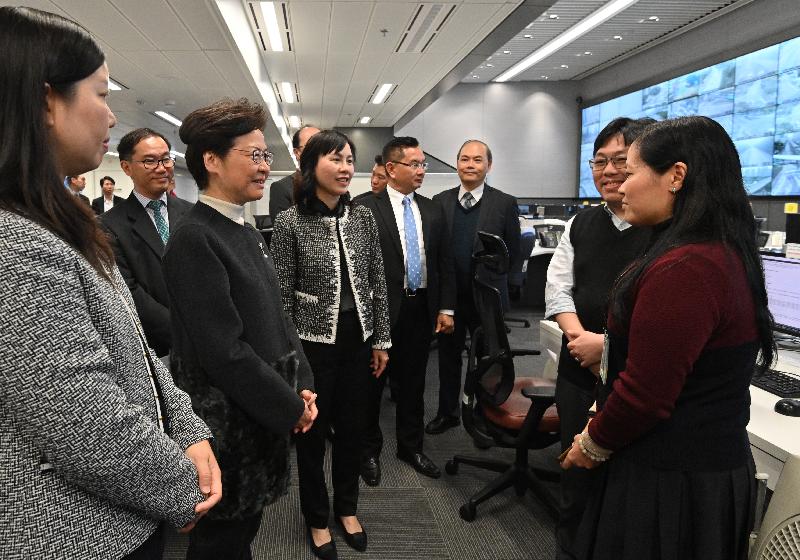 The Chief Executive, Mrs Carrie Lam, visited the Electrical and Mechanical Services Department (EMSD) and the Transport Department today (December 30) to learn more about the measures and recovery work taken by the two departments in response to the protests and vandalistic acts in recent months. Photo shows Mrs Lam (third left), accompanied by the Commissioner for Transport, Ms Mable Chan (fourth left), chatting with staff members at the Emergency Transport Coordination Centre.