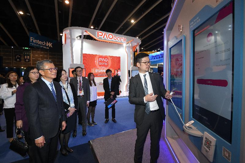 The Financial Secretary, Mr Paul Chan (third left), visits exhibition booths at the 13th Asian Financial Forum at the Hong Kong Convention and Exhibition Centre today (January 13). 