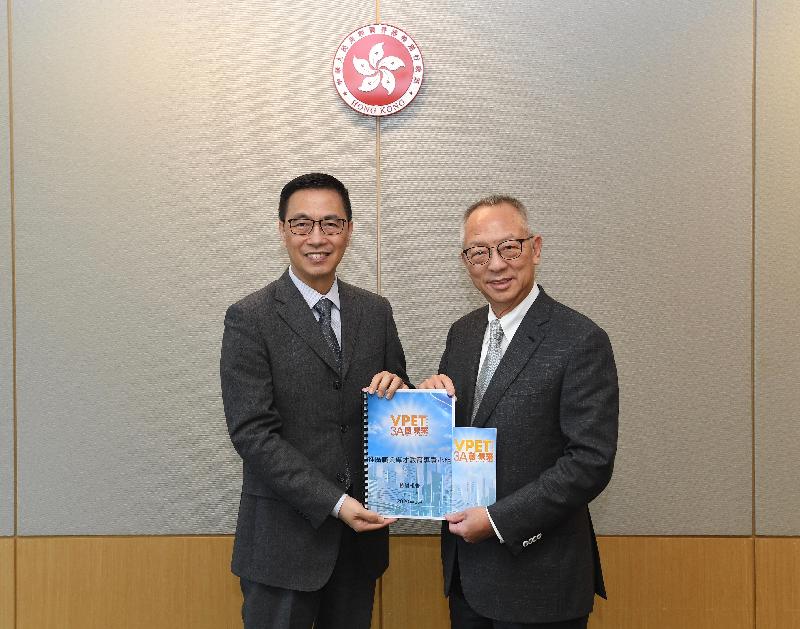 The Chairman of the Task Force on Promotion of Vocational and Professional Education and Training, Dr Roy Chung (right), submits the Task Force's review report to the Secretary for Education, Mr Kevin Yeung (left), today (January 23).
