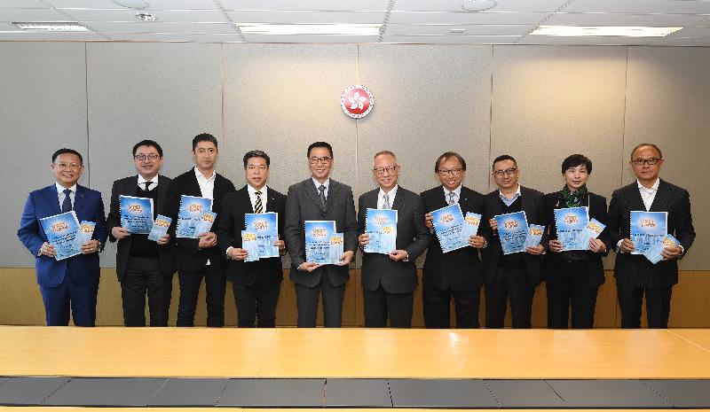 The Chairman of the Task Force on Promotion of Vocational and Professional Education and Training, Dr Roy Chung (fifth right), submits the Task Force's review report to the Secretary for Education, Mr Kevin Yeung (fifth left), today (January 23). They are pictured with the Task Force members. 
