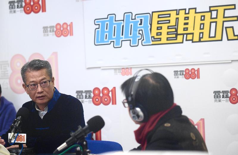 The Financial Secretary, Mr Paul Chan (left), attends Commercial Radio's "Beautiful Sunday" this morning (January 26).