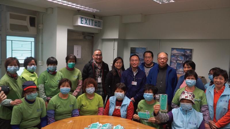 The Food and Environmental Hygiene Department and the Housing Department have today (February 17) started distributing masks to cleansing workers who are responsible for cleaning public toilets, public markets, refuse collection points, streets and public housing estates. Photo shows the Secretary for Transport and Housing, Mr Frank Chan Fan (back row, ninth left), visits a public housing estate in Shau Kei Wan today  to understand the distribution of masks to cleansing workers.  