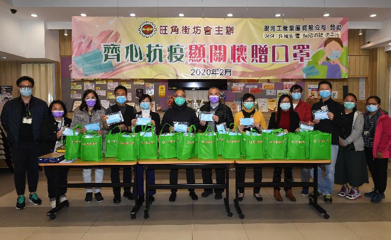 民政事務局局長劉江華（左六）今日（二月十七日）到訪居於旺角的市民，為他們送上包括口罩的抗疫用品。