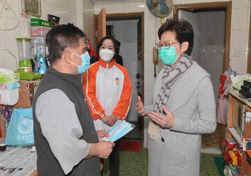 The Chief Executive, Mrs Carrie Lam (right), visits Lok Sin Tong Social Housing Scheme at Kowloon City this evening (February 17) to distribute disease prevention items including surgical masks to grass-roots families and learn about their daily lives.