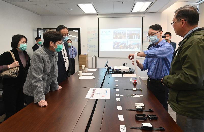 The Chief Executive, Mrs Carrie Lam, visited the Logistics and Supply Chain MultiTech R&D Centre at the Hong Kong Science Park this afternoon (February 20) to learn about its research and development and production of electronic wristbands for the Government's home quarantine measure. Photo shows Mrs Lam (third left), accompanied by the Secretary for Innovation and Technology, Mr Nicholas W Yang (fourth left), was briefed about the research and development and production of the wristbands. 
