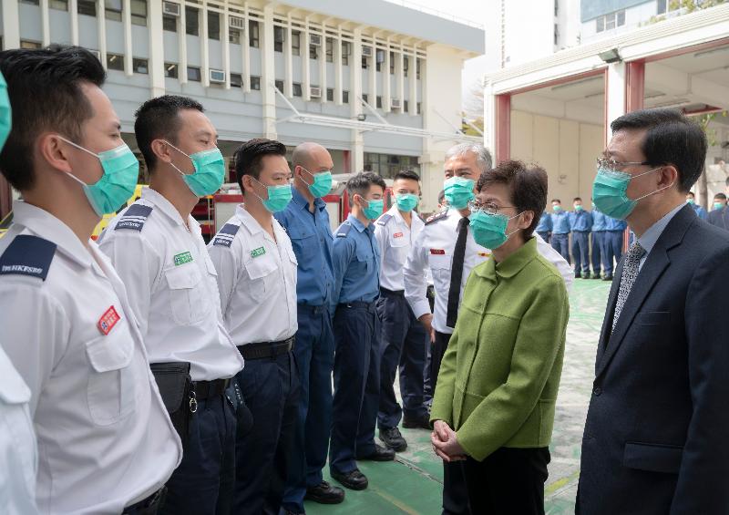 The Chief Executive, Mrs Carrie Lam, visited Lei Muk Shue Fire Station cum Ambulance Depot in Kwai Chung today (February 28), expressing her gratitude to firemen and ambulancemen for fighting the infection at the forefront, providing emergency services to the public day and night. Photo shows Mrs Lam (second right), accompanied by the Secretary for Security, Mr John Lee (first right), and the Director of Fire Services, Mr Li Kin-yat (third right), chatting with frontline ambulancemen and firemen.