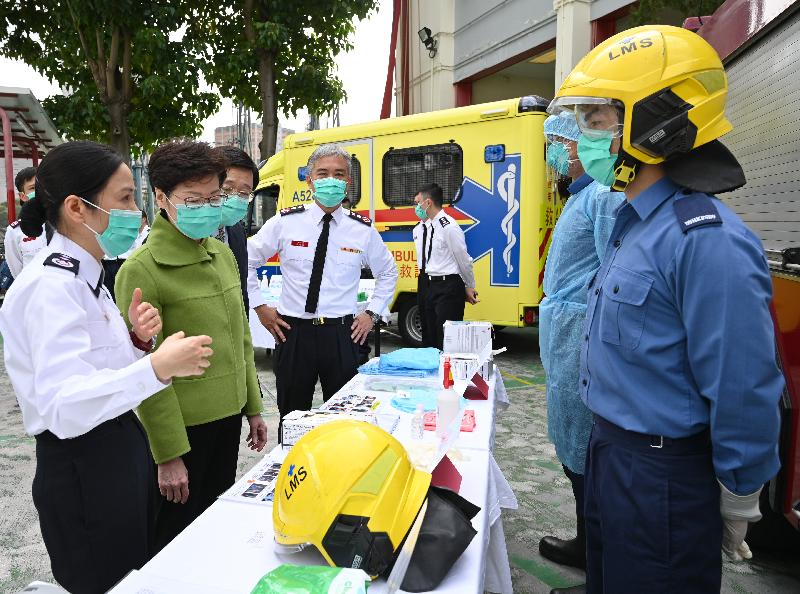 The Chief Executive, Mrs Carrie Lam, visited Lei Muk Shue Fire Station cum Ambulance Depot in Kwai Chung today (February 28), expressing her gratitude to firemen and ambulancemen for fighting the infection at the forefront, providing emergency services to the public day and night. Photo shows Mrs Lam (second left), accompanied by the Secretary for Security, Mr John Lee (third left), and the Director of Fire Services, Mr Li Kin-yat (fourth left), receiving a briefing by the Deputy Chief Ambulance Officer of the Fire Services Department, Ms Tsang Man-ha (first left), on the personal protective equipment of frontline officers. 