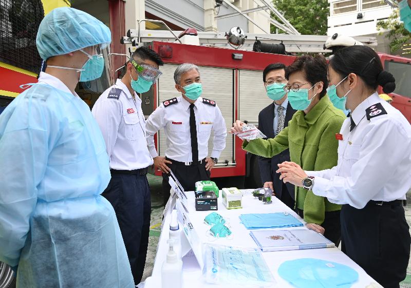 The Chief Executive, Mrs Carrie Lam, visited Lei Muk Shue Fire Station cum Ambulance Depot in Kwai Chung today (February 28), expressing her gratitude to firemen and ambulancemen for fighting the infection at the forefront, providing emergency services to the public day and night. Photo shows Mrs Lam (second right), accompanied by the Secretary for Security, Mr John Lee (third right), and the Director of Fire Services, Mr Li Kin-yat (fourth right), learning about the personal protective equipment of frontline officers.