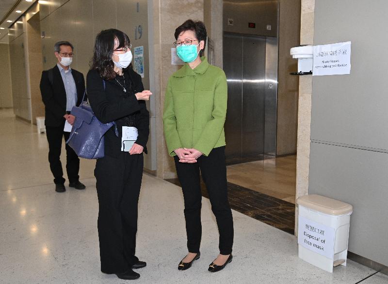 After visiting Lei Muk Shue Fire Station cum Ambulance Depot in Kwai Chung, the Chief Executive, Mrs Carrie Lam, visited the Queensway Government Offices today (February 28) to inspect the infection control measures to be implemented to prepare for the gradual resumption of more public services next Monday (March 2). Photo shows Mrs Lam (first right) receiving a briefing by the Government Property Administrator, Ms Leonia Tai (second right), on the relevant measures.