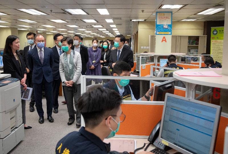 The Chief Executive, Mrs Carrie Lam, visited the office of the Assistance to Hong Kong Residents Unit of the Immigration Department (ImmD) in Wan Chai this afternoon (March 2), expressing her gratitude to personnel of the ImmD for standing fast at their posts during the epidemic. Photo shows Mrs Lam (front row, third left), accompanied by the Secretary for Security, Mr John Lee (front row, fourth left) and the Director of Immigration, Mr Erick Tsang (front row, second left), learning about the work situation of Immigration officers. 