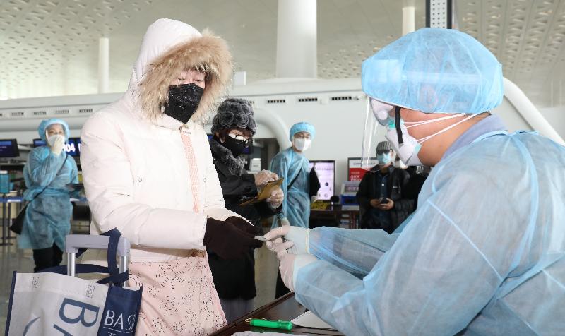 Staff members from the Immigration Department doing registration for Hong Kong residents stranded in Hubei Province at the Wuhan Tianhe International Airport today (March 4) before they board the chartered flight back to Hong Kong.