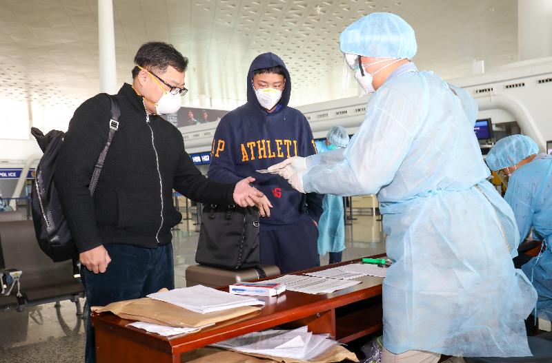 Staff members from the Immigration Department doing registration for Hong Kong residents stranded in Hubei Province at the Wuhan Tianhe International Airport today (March 4) before they board the chartered flight back to Hong Kong.