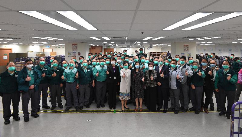 The Chief Executive, Mrs Carrie Lam, visited the Kowloon Speedpost Operations Centre at Lei Yue Mun Estate in Yau Tong today (March 6). Photo shows Mrs Lam (front row, ninth left), accompanied by the Postmaster General, Miss Cathy Chu (front row, 10th left), with postal staff.