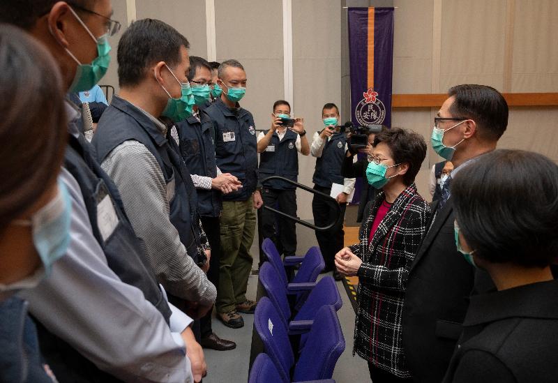 The Chief Executive, Mrs Carrie Lam (third right), visited the Civil Aid Service (CAS) Headquarters in Yau Ma Tei this afternoon (March 11) to thank members of the CAS for assisting in the setting-up and management of the quarantine centres to protect people's health. Photo shows Mrs Lam chatting with members of the CAS who have participated in the quarantine centres work. Looking on is the Commissioner of the CAS, Mr Lo Yan-lai (second right).