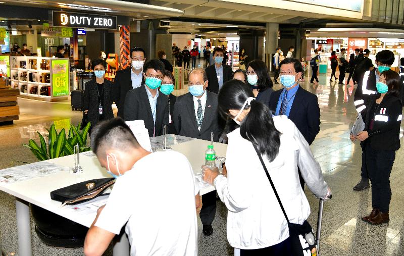 The Chief Secretary for Administration, Mr Matthew Cheung Kin-chung, today (March 13) visited Hong Kong International Airport to observe the implementation of the health declaration measure that has been extended to all inbound travellers arriving in Hong Kong. Photo shows Mr Cheung (first row, second left), accompanied by the Chief Executive Officer of the Airport Authority Hong Kong, Mr Fred Lam (first row, first right); the Chief Port Health Officer of the Centre for Health Protection of the Department of Health, Dr Leung Yiu-hong (first row, first left); and the Executive Director, Airport Operations, of the Airport Authority Hong Kong, Mrs Vivian Cheung (second row, second right), learning about the implementation of the requirement that all inbound travellers arriving at the airport should complete a health declaration form.