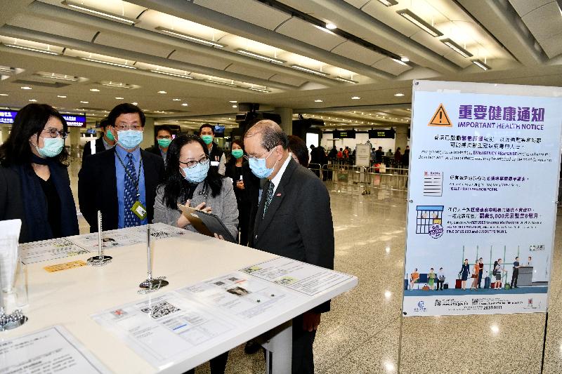 The Chief Secretary for Administration, Mr Matthew Cheung Kin-chung, today (March 13) visited Hong Kong International Airport to observe the implementation of the health declaration measure that has been extended to all inbound travellers arriving in Hong Kong. Photo shows Mr Cheung (first right), accompanied by the Chief Executive Officer of the Airport Authority Hong Kong, Mr Fred Lam (second left), and the Executive Director, Airport Operations, of the Airport Authority Hong Kong, Mrs Vivian Cheung (first left), receiving a briefing from staff of the Health Informatics and Technology Office of the Department of Health on the operation of the "Electronic Health Declaration Form" system.