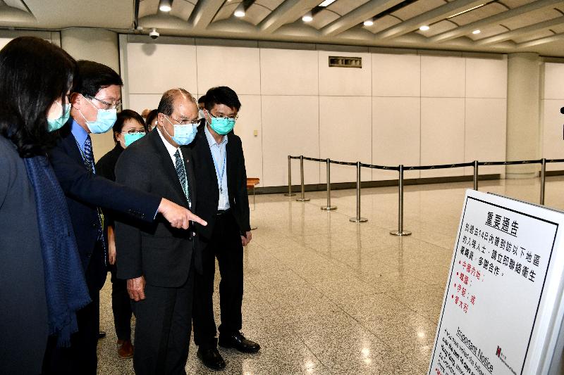 The Chief Secretary for Administration, Mr Matthew Cheung Kin-chung, today (March 13) visited Hong Kong International Airport to observe the implementation of the health declaration measure that has been extended to all inbound travellers arriving in Hong Kong. Photo shows Mr Cheung (second right), accompanied by the Chief Executive Officer of the Airport Authority Hong Kong, Mr Fred Lam (second left); the Chief Port Health Officer of the Centre for Health Protection of the Department of Health, Dr Leung Yiu-hong (first right); and the Executive Director, Airport Operations, of the Airport Authority Hong Kong, Mrs Vivian Cheung (first left), learning about the arrangement on issuing quarantine orders to inbound travellers arriving in Hong Kong.
