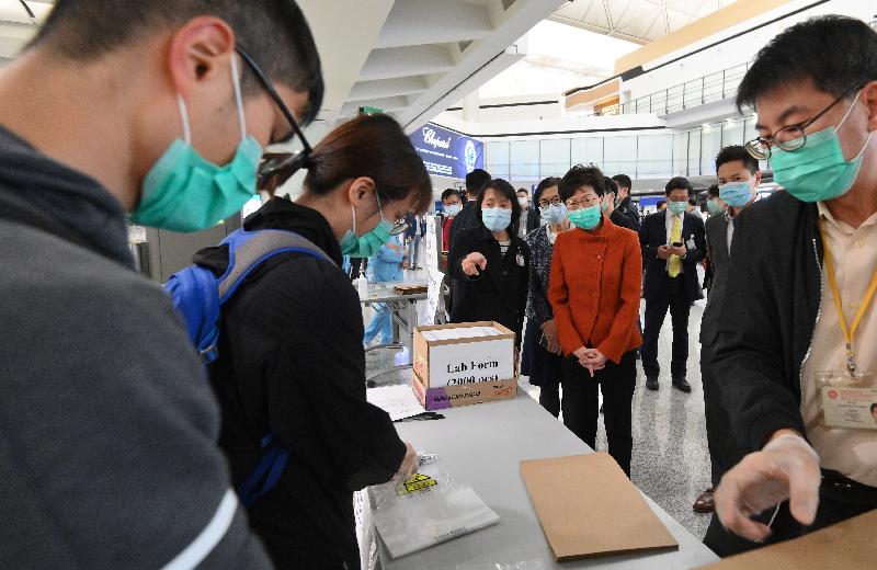 The Chief Executive, Mrs Carrie Lam (fourth right), accompanied by the Secretary for Food and Health, Professor Sophia Chan (fifth right) and the Chief Executive Officer of the Airport Authority Hong Kong, Mr Fred Lam (third right), visited the Hong Kong International Airport this afternoon (March 19) to inspect the implementation of compulsory quarantine measures on all persons arriving from overseas countries and territories starting from 0.00am today.