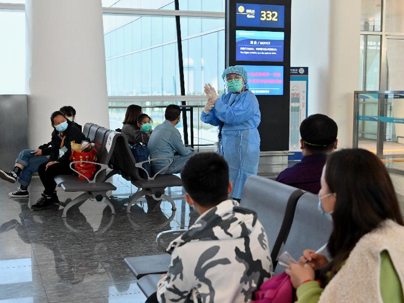 A nurse from the Department of Health shows the proper way of washing hands to Hong Kong residents who are to board the chartered flight back to Hong Kong at the Wuhan Tianhe International Airport today (March 26).