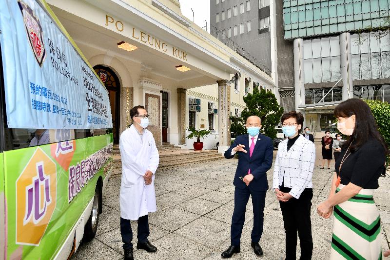 The Chief Executive, Mrs Carrie Lam, went to the headquarters of Po Leung Kuk (PLK) in Causeway Bay this afternoon (March 31) to visit its mobile Chinese medicine clinic and learn about its work in supporting the underprivileged during the epidemic. Photo shows Mrs Lam (second right) receiving a briefing from the Chairman of the Board of Directors of PLK, Mr Ma Ching-nam (second left).