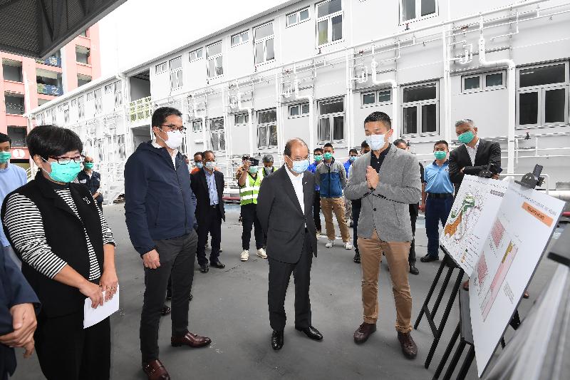 The Chief Secretary for Administration, Mr Matthew Cheung Kin-chung, today (April 23) visited the Junior Police Call Permanent Activity Centre at Pat Heung, Yuen Long, to inspect the newly developed quarantine units that will soon commence operation. Photo shows Mr Cheung (front row, second right), accompanied by the Secretary for Development, Mr Michael Wong (front row, second left), and the Director of Architectural Services, Mrs Sylvia Lam (front row, first left), receiving a briefing from technical staff on-site on the development process and how they sped up the construction by adopting the modular integrated construction (MiC) method.