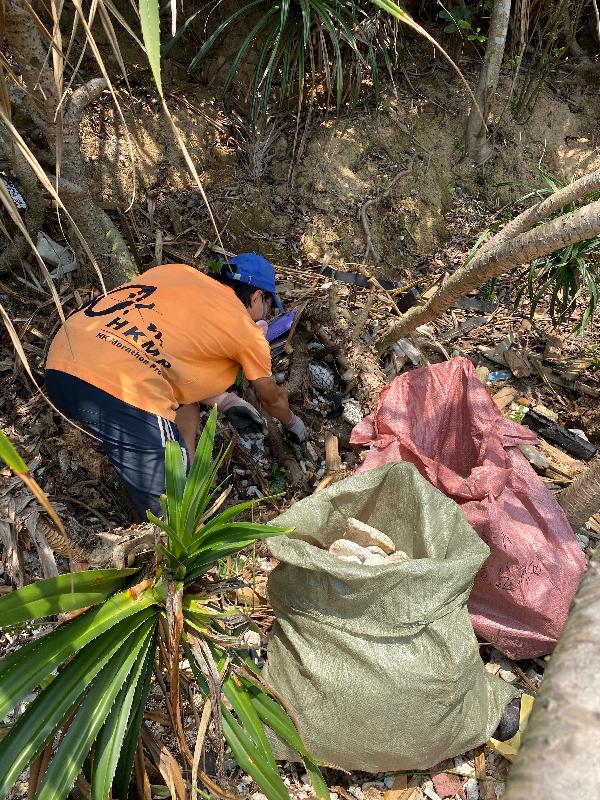 多个政府部门联同一众义工今日（四月二十七日）在塔门弓背湾进行联合净滩行动。图示义工在石滩清理垃圾。