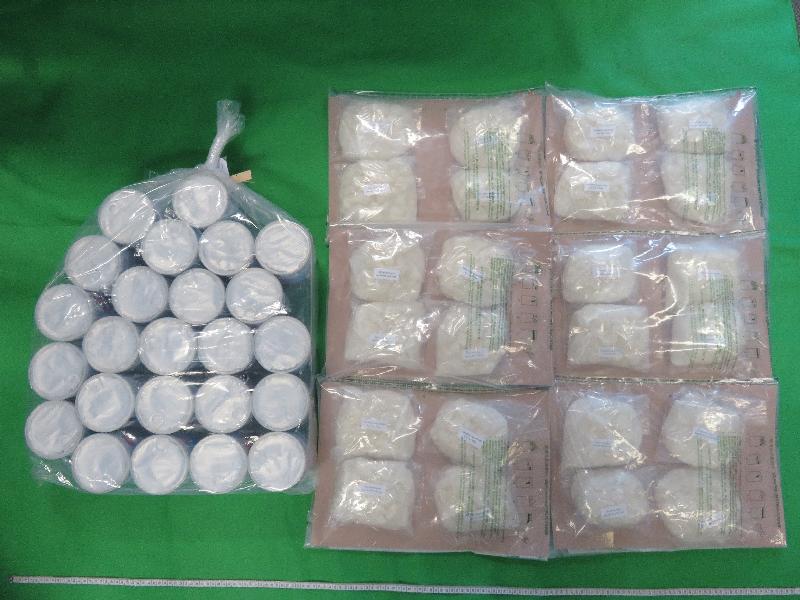 Hong Kong Customs seized about 10 kilograms of suspected ketamine with an estimated market value of about $5 million at Hong Kong International Airport on May 3. Photo shows the suspected ketamine seized and 24 milk powder cans used to conceal the dangerous drugs.