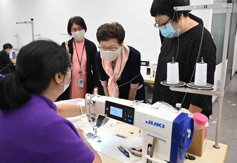 The Chief Executive, Mrs Carrie Lam (second right), this morning (May 6) inspected one of the production sites of CuMask+™ in Tsuen Wan. Photo shows Mrs Lam chatting with a worker. Looking on is the Permanent Secretary for Innovation and Technology, Ms Annie Choi (third right).