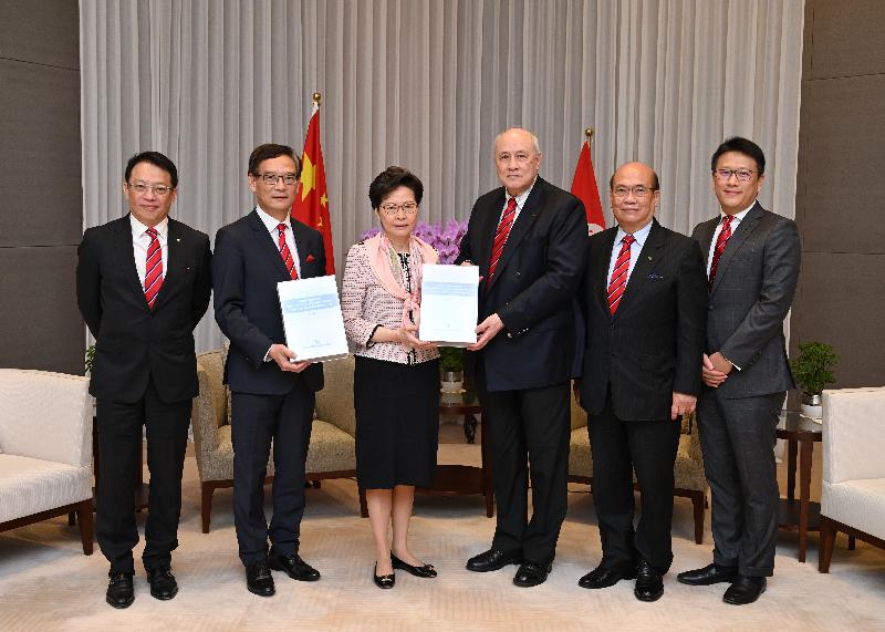 The Chief Executive, Mrs Carrie Lam (third left), receives today (May 15) from the Chairman of the Independent Police Complaints Council (IPCC), Mr Anthony Neoh, SC (third right), and IPCC Vice-chairman Mr Tony Tse (second left) the Thematic Study on the Public Order Events arising from the Fugitive Offenders Bill since June 2019 and the Police Actions in Response. Looking on are IPCC members Mr Clement Chan (first left), Mr Herman Hui (second right) and Mr Douglas Lam, SC (first right).