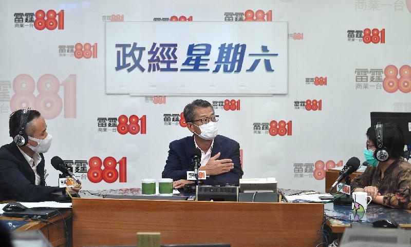 The Financial Secretary, Mr Paul Chan (centre), attends Commercial Radio's programme "Saturday Forum" this morning (June 13).