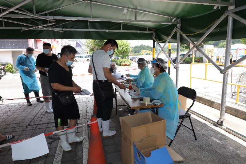 The Food and Environmental Hygiene Department today (July 29) arranged the COVID-19 testing for stakeholders of Sheung Shui Slaughterhouse (SSSH), including the operator, importers, buyers and transportation companies. Photo shows the testing agency collecting deep throat saliva samples from stakeholders of SSSH for testing.

