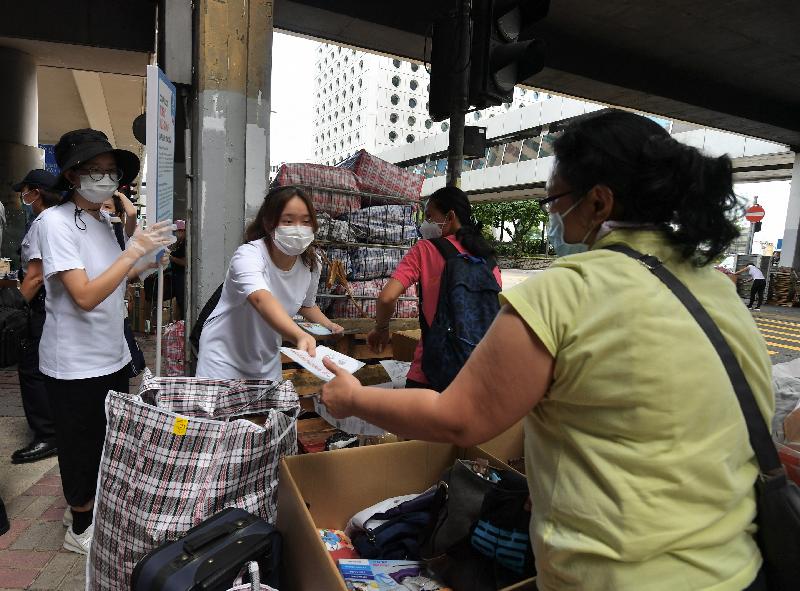 The Labour Department, in collaboration with the Hong Kong Police Force and the Food and Environmental Hygiene Department, starting from today (August 8), conducted mobile broadcasts for two consecutive days in popular gathering places of foreign domestic helpers (FDHs) to call upon them to comply with the regulations on the prohibition of group gatherings and mask-wearing requirement in public places. Photo shows promotional leaflets being distributed by the Labour Department to FDHs in Connaught Road Central near World Wide House in Central. 