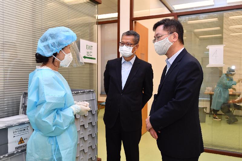 The Financial Secretary, Mr Paul Chan, today (September 4) visited the community testing centre at the Hong Kong Science Park to inspect the operation of the centre. Photo shows Mr Chan (centre) and the Secretary for Innovation and Technology, Mr Alfred Sit (right), being briefed by a staff member on the operation of the centre.