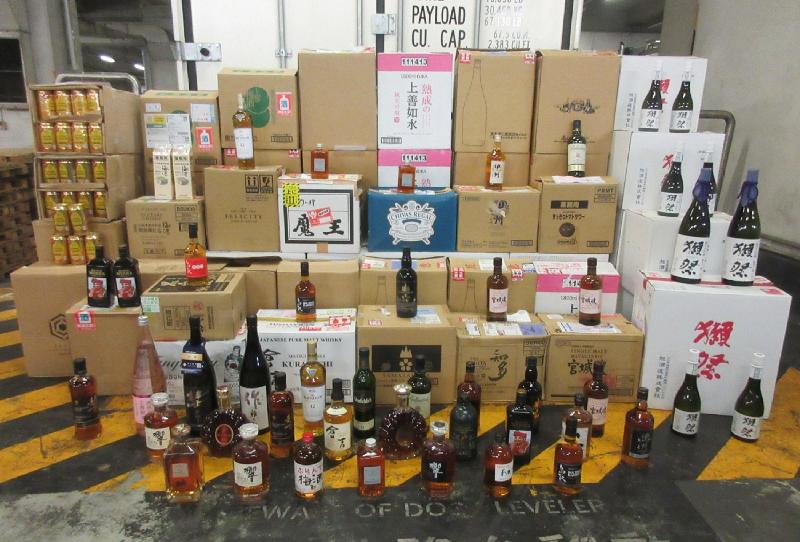 Hong Kong Customs detected three suspected cases of smuggling illicit liquor through seaborne containers between late May and early September. A total of about 350 litres in 550 bottles of suspected duty-not-paid liquor, about 3 240 litres in 3 730 bottles of suspected smuggled sake, about 130 litres in 380 cans of suspected smuggled beer and a batch of suspected smuggled assorted goods were seized. The total estimated market value was about $1.2 million with a duty potential of about $150,000. Photo shows some of the liquor, sake and beer involved in the cases.