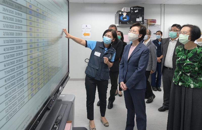 The Chief Executive, Mrs Carrie Lam (fifth right), visited the newly completed Penny's Bay Quarantine Centre Phase 2 on Lantau Island this afternoon (September 29). Photo shows Mrs Lam being briefed by a member of the Civil Aid Service on the operation of the quarantine centre at the command post. Looking on are the Secretary for Food and Health, Professor Sophia Chan (first right), and the Permanent Secretary for Development (Works), Mr Lam Sai-hung (second right).