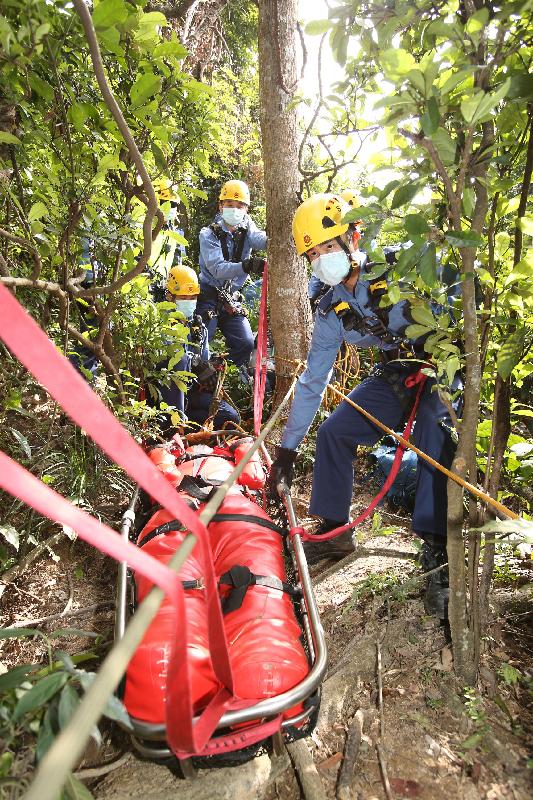 Fire Services personnel simulate the rescue of injured persons during an inter-departmental vegetation fire and mountain rescue operation exercise today (October 20).
