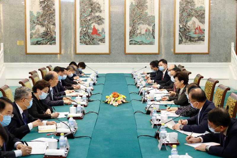 The Chief Executive, Mrs Carrie Lam (fourth right), meets with the Chairman of the China Securities Regulatory Commission, Mr Yi Huiman (fourth left), in Beijing today (November 5). The Secretary for Transport and Housing, Mr Frank Chan Fan (sixth right); the Secretary for Food and Health, Professor Sophia Chan (third right); the Secretary for Innovation and Technology, Mr Alfred Sit (seventh right); the Secretary for Constitutional and Mainland Affairs, Mr Erick Tsang Kwok-wai (second right); the Secretary for Financial Services and the Treasury, Mr Christopher Hui (fifth right); and the Director of the Chief Executive's Office, Mr Chan Kwok-ki (first right), also joined the meeting.