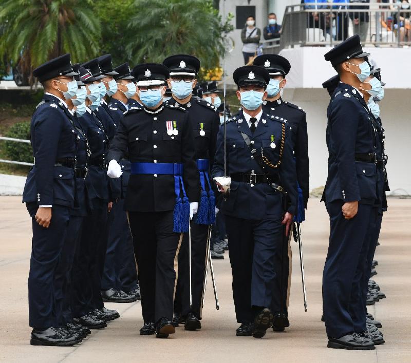 The Commissioner of Police, Mr Tang Ping-keung (second left), inspects a passing-out parade as a reviewing officer at the Hong Kong Police College today (November 21).