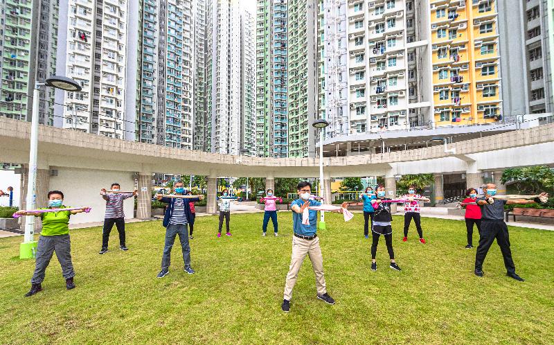 The Hong Kong Housing Authority has produced a series of videos, "Fitness Exercise for the Elderly", featuring a set of simple exercises specially designed for its elderly tenants so that they can practise at home conveniently through visual learning. Photo shows Deputy Director of Housing (Estate Management), Mr Ricky Yeung (front row, centre) and Assistant Director (Estate Management) 1, Mr Ian Luk (second row, second left) exercised with elderly tenants at Kai Ching Estate, Kowloon City on the filming day.