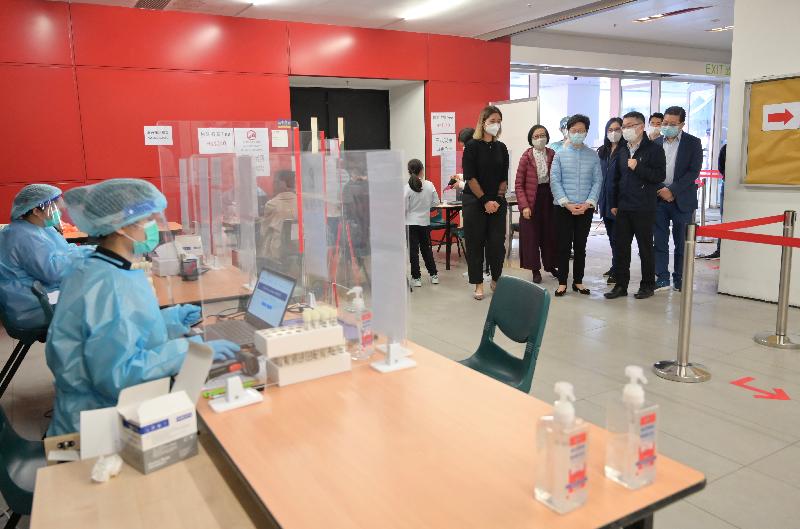 The Chief Executive, Mrs Carrie Lam (fifth right), accompanied by the Secretary for Food and Health, Professor Sophia Chan (second left), visits the community testing centre at Hang Hau Community Hall today (December 6).
