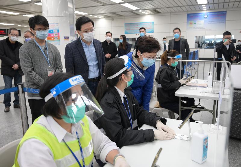 The Chief Executive, Mrs Carrie Lam, visited the Shenzhen Bay Control Point and Hong Kong-Zhuhai-Macao Bridge Control Point today (December 27) to inspect the implementation of the Return2hk – Travel Scheme  for Hong Kong Residents returning from Guangdong Province or Macao without being subject to quarantine. Photo shows Mrs Lam (front row, third left) chatting with frontline officers at the Shenzhen Bay Control Point. Looking on is the Secretary for Security, Mr John Lee (back row, second left).