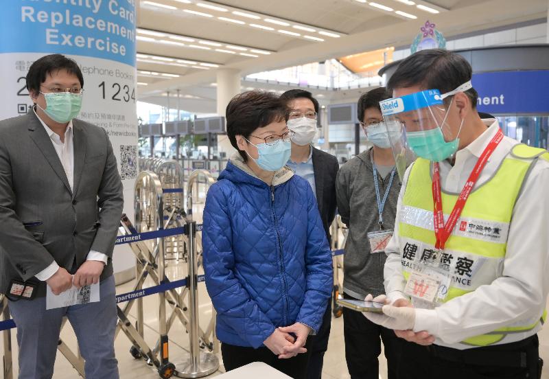 The Chief Executive, Mrs Carrie Lam, visited the Shenzhen Bay Control Point and Hong Kong-Zhuhai-Macao Bridge (HZMB) Control Point today (December 27) to inspect the implementation of the Return2hk – Travel Scheme for Hong Kong Residents returning from Guangdong Province or Macao without being subject to quarantine. Photo shows Mrs Lam (second left), accompanied by the Secretary for Security, Mr John Lee (third left), chatting with frontline officers at the HZMB Control Point to learn about the quarantine procedures of Hong Kong residents returning to Hong Kong. 

