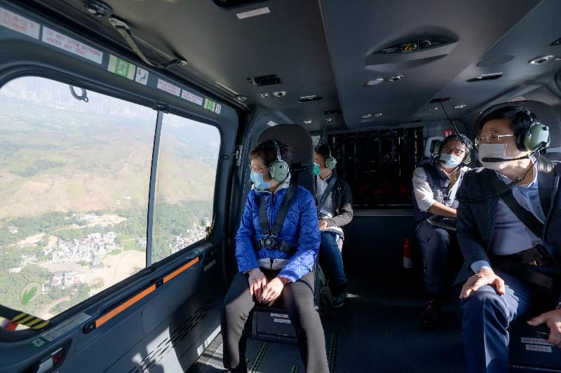 Mrs Carrie Lam today (December 27), accompanied by the Secretary for Security, Mr John Lee and the Secretary for Development, Mr Michael Wong, visited the headquarters of the Government Flying Service, and took a helicopter tour to view sites related to various development plans she proposed in the 2020 Policy Address. Picture shows Mrs Lam taking the helicopter tour.