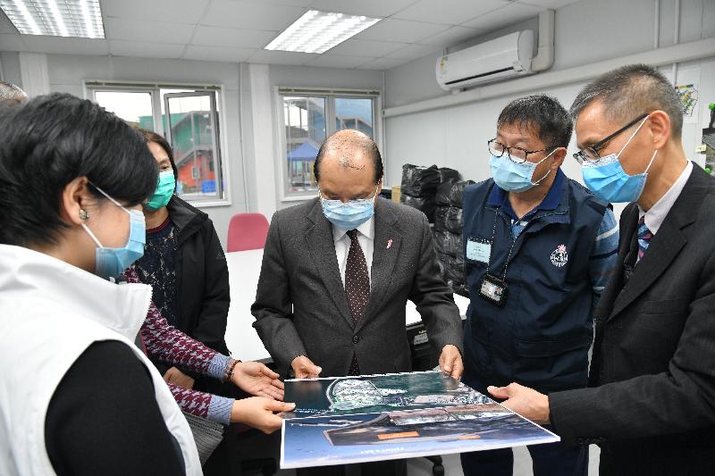The Chief Secretary for Administration, Mr Matthew Cheung Kin-chung, inspected Penny’s Bay Quarantine Centre on Lantau Island this evening (December 29) to learn about its latest operations. Photo shows Mr Cheung (third right) receiving a briefing from the Director of Architectural Services, Ms Winnie Ho (first left), on the layout of the site and urgent clearing of trash found in manhole.
