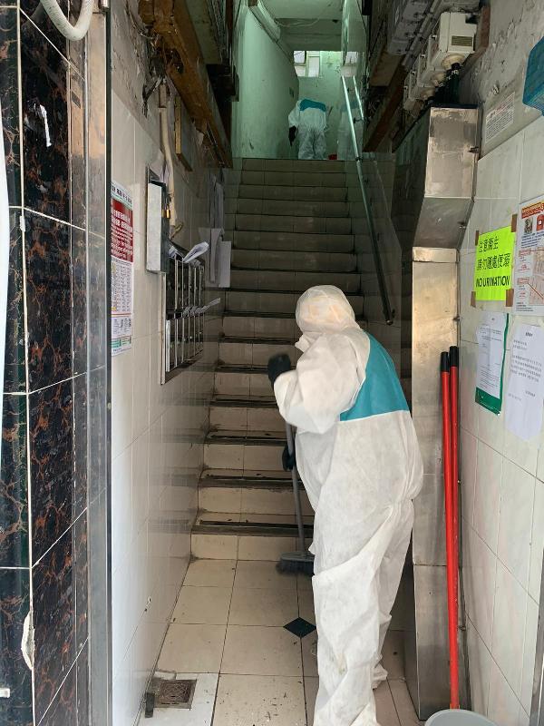 The Home Affairs Department has since January 25 been providing one-off enhanced cleaning services to buildings with confirmed cases or subject to compulsory testing. Photo shows contractor staff carrying out cleaning work in one of the buildings.