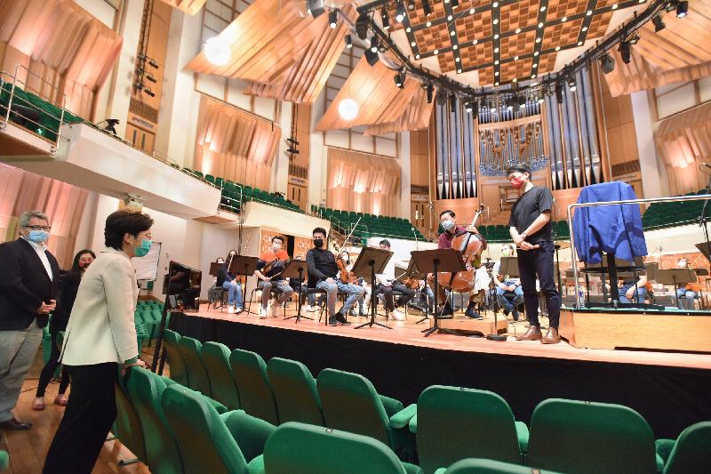 The Chief Executive, Mrs Carrie Lam, this afternoon (February 19) visited the Hong Kong Cultural Centre which reopened today. Photo shows Mrs Lam (second left) chatting with musicians of the Hong Kong Philharmonic Orchestra, which is rehearsing at the concert hall.