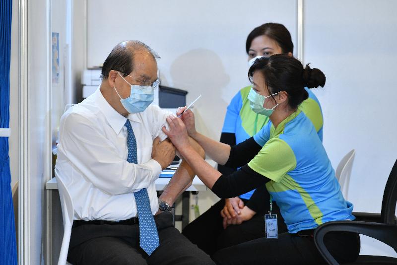 The Chief Executive, Mrs Carrie Lam, with a number of Department Secretaries and Bureaux Directors, received COVID-19 vaccinations today (February 22) at the Community Vaccination Centre at the Hong Kong Central Library Exhibition Gallery. Photo shows the Chief Secretary for Administration, Mr Matthew Cheung Kin-chung (left), receiving the vaccine.