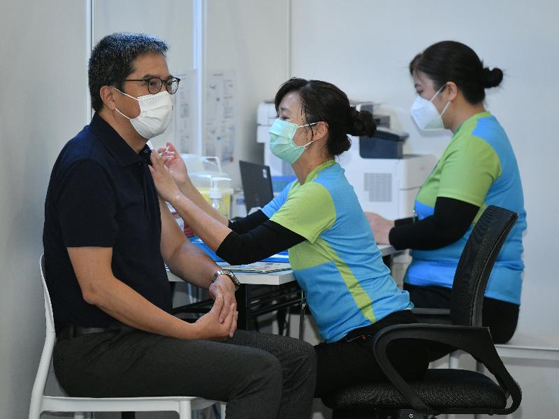 The Secretary for Development, Mr Michael Wong (left), receives COVID-19 vaccination today (February 22) at the Community Vaccination Centre at the Hong Kong Central Library Exhibition Gallery.