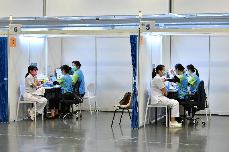 Around 200 people in the vaccination priority groups today (February 23) received COVID-19 vaccination at the Community Vaccination Centre at the Exhibition Gallery of the Hong Kong Central Library. Photo shows staff members of residential care homes for the elderly getting vaccinated.