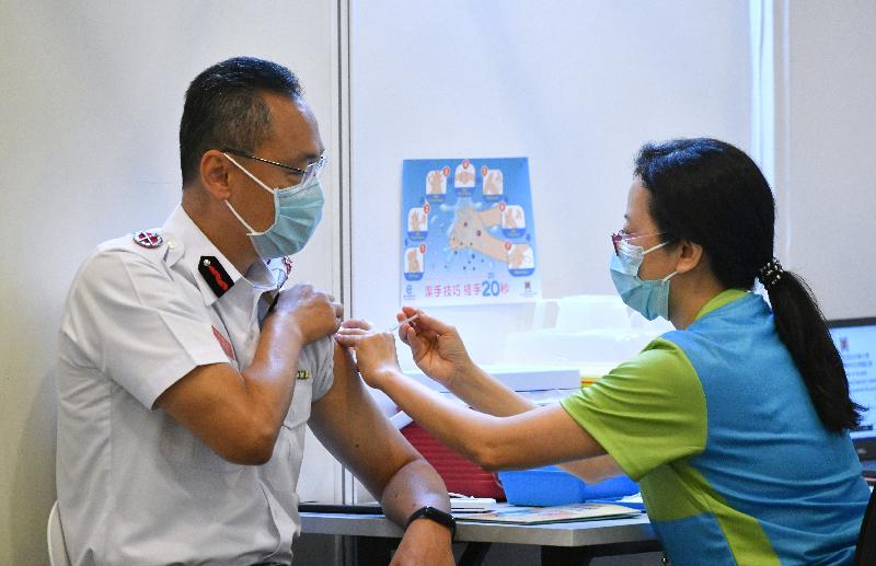 The Director of Fire Services, Mr Joseph Leung (left), receives COVID-19 vaccination today (February 23) at the Community Vaccination Centre at the Hong Kong Central Library Exhibition Gallery.